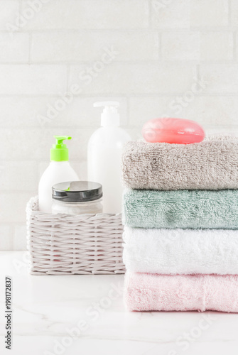 Spa relax and bath concept, sea salt, soap, with cosmetics and towels in bathroom white background, copy space top view