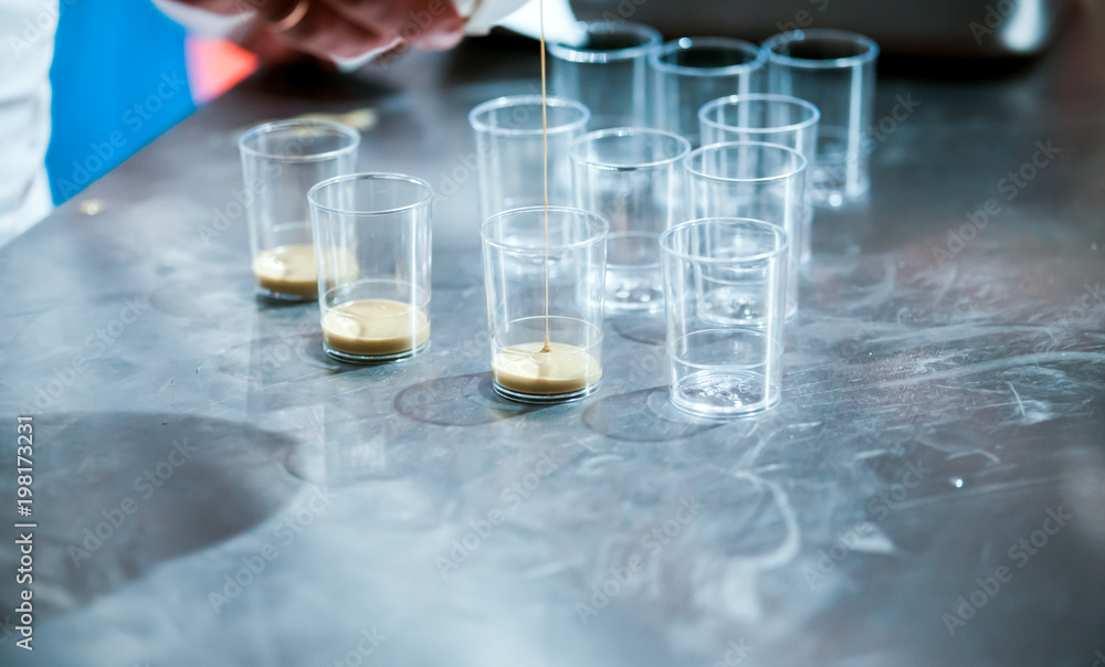 Confectioner preparing cream in pastry shop, food industry Confectioner preparing cream in pastry shop, food industry