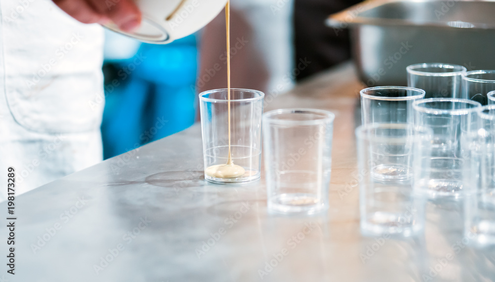Confectioner preparing cream in pastry shop, food industry Confectioner preparing cream in pastry shop, food industry