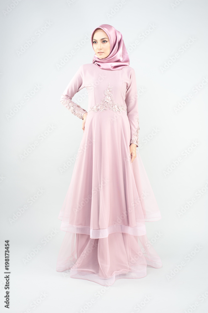 Beautiful muslim girl wearing pink asian dress known as Baju Kurung with Hijab.Hijab fashion for Eid Mubarak.Studio Shoot. Beautiful muslim girl wearing pink asian dress known as Baju Kurung with Hijab.Hijab fashion for Eid Mubarak.Studio Shoot.