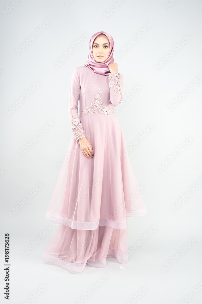 Beautiful muslim girl wearing pink asian dress known as Baju Kurung with Hijab.Hijab fashion for Eid Mubarak.Studio Shoot. Beautiful muslim girl wearing pink asian dress known as Baju Kurung with Hijab.Hijab fashion for Eid Mubarak.Studio Shoot.