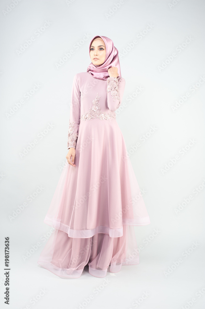 Beautiful muslim girl wearing pink asian dress known as Baju Kurung with Hijab.Hijab fashion for Eid Mubarak.Studio Shoot.