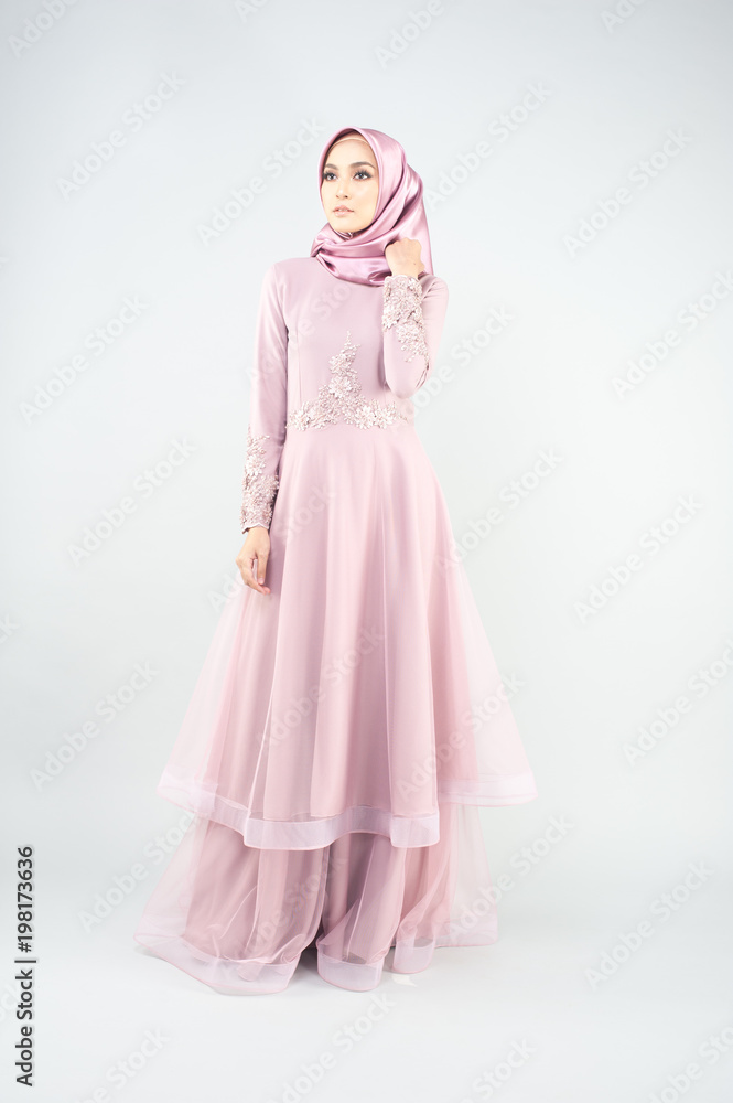 Beautiful muslim girl wearing pink asian dress known as Baju Kurung with Hijab.Hijab fashion for Eid Mubarak.Studio Shoot. Beautiful muslim girl wearing pink asian dress known as Baju Kurung with Hijab.Hijab fashion for Eid Mubarak.Studio Shoot.