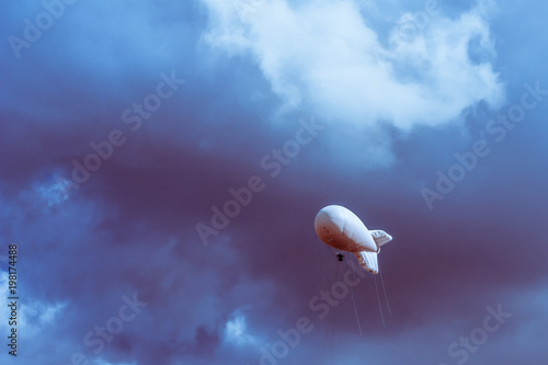 Military Aerostat in a beautiful sky with dramatic clouds photo