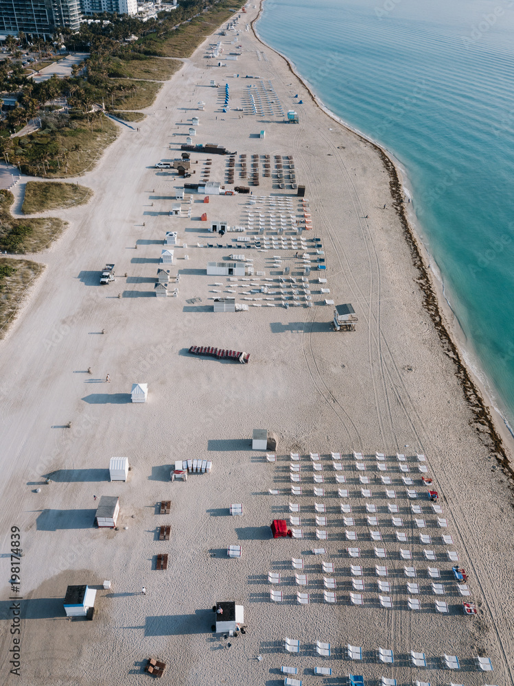 Fototapeta premium Aerial view of sandy beach with sun loungers, Miami Beach, Florida, USA