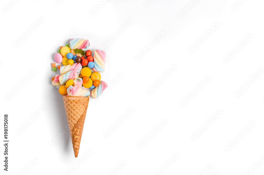 Ice cream cone flat lay image with colorful candy packing into the cone. Ice cream cone flat lay image with colorful candy packing into the cone.