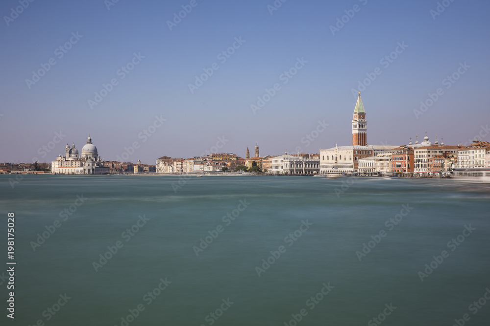 Long exposure view of the blue turquoise lagoon of Venice with the Campanile in the background, Venice, Italy