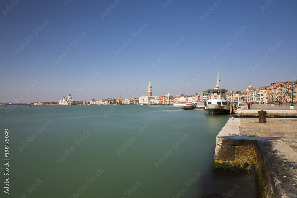 Long exposure view of the blue turquoise lagoon of Venice with the Campanile in the background, Venice, Italy