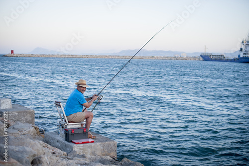 Mature Man Fishing in the Sea