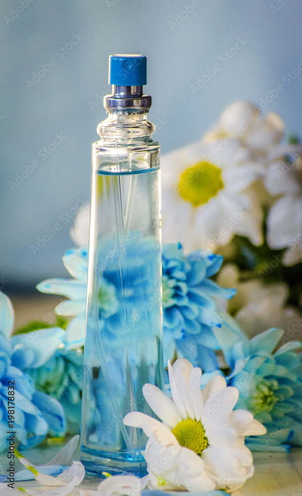 perfume bottle on a background of flowers perfume bottle on a background of flowers