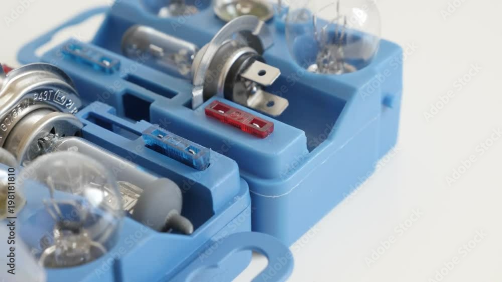 Spare bulbs in a box on white background close-up footage - Slow tilt on opened new car lighting accessories package Spare bulbs in a box on white background close-up footage - Slow tilt on opened new car lighting accessories package