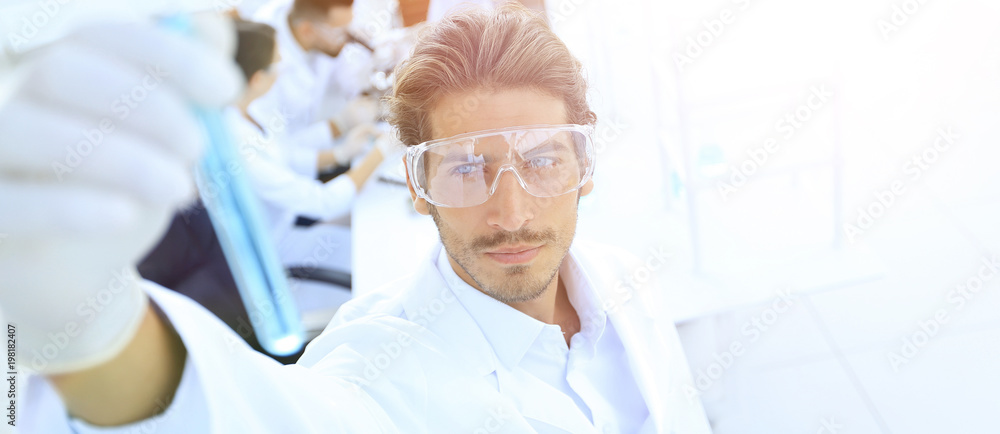 tube with reagents on blurred background laboratory. tube with reagents on blurred background laboratory.