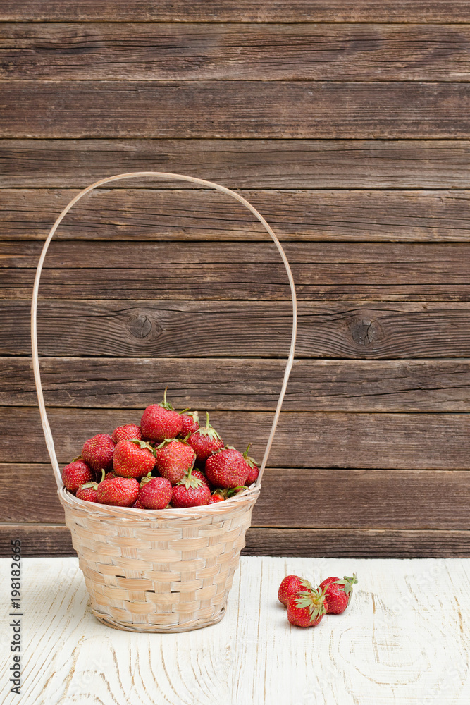 Basket of ripe strawberries on a wooden background. Space for text Basket of ripe strawberries on a wooden background. Space for text