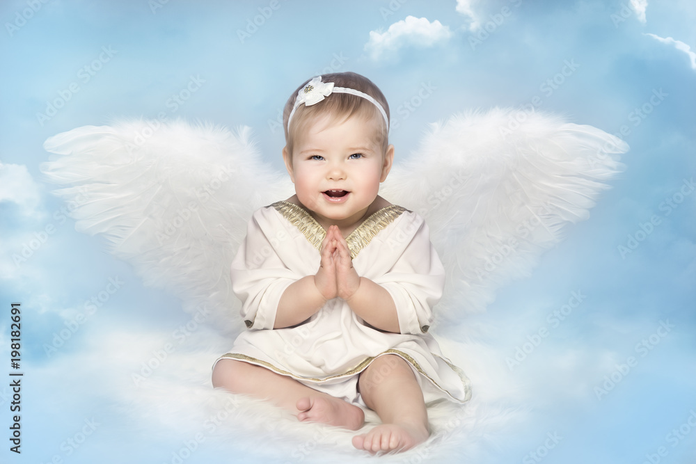 Angel Baby with Amur Wings, Kid Cupid Sitting on Blur Sky, Happy Girl Child Portrait Angel Baby with Amur Wings, Kid Cupid Sitting on Blur Sky, Happy Girl Child Portrait