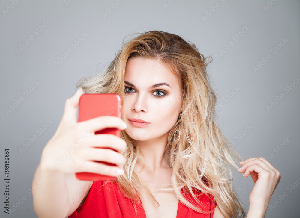 Young beautiful woman making selfie photo on smartphone. Fashion model girl with cell phone Young beautiful woman making selfie photo on smartphone. Fashion model girl with cell phone