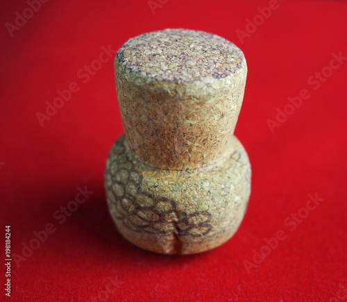 Champagne cork. Isolated on red background, macro, close-up.
