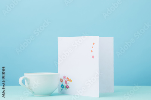 Love background with card and cup gift on table