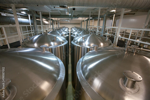 Huge Tanks of white metal, which brewed beer in the brewery, the top view
