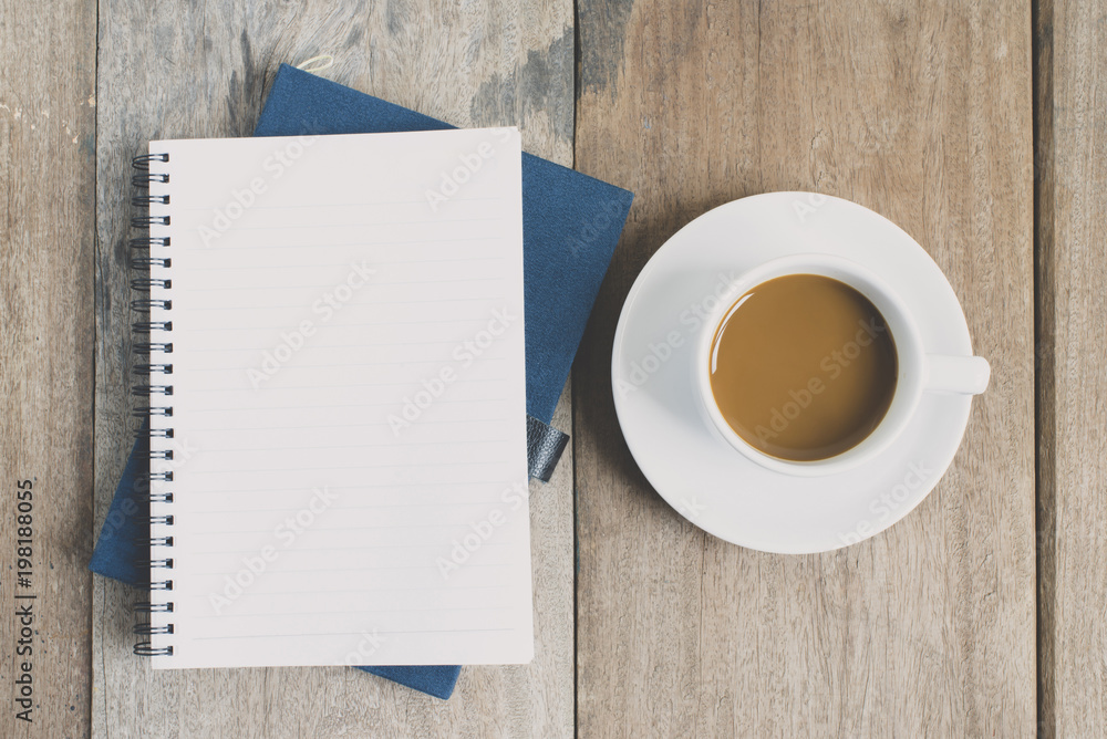 top view a cup of coffee with paper and note book top view a cup of coffee with paper and note book