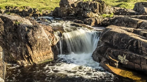 Dolly shot time lapse with long time exposure of the paradisal waterfall landscape in Glen Etive, Scotland - United Kingdom photo