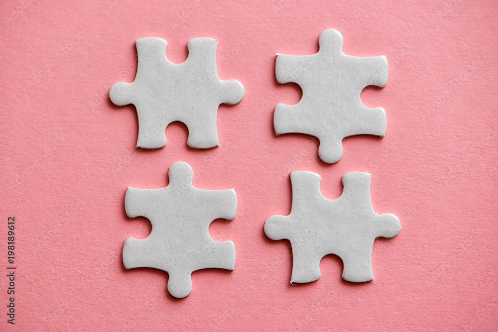 four white details of puzzle on pink background four white details of puzzle on pink background