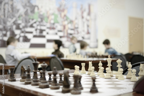 Chess competition at school. Wooden chess pieces on the table. 