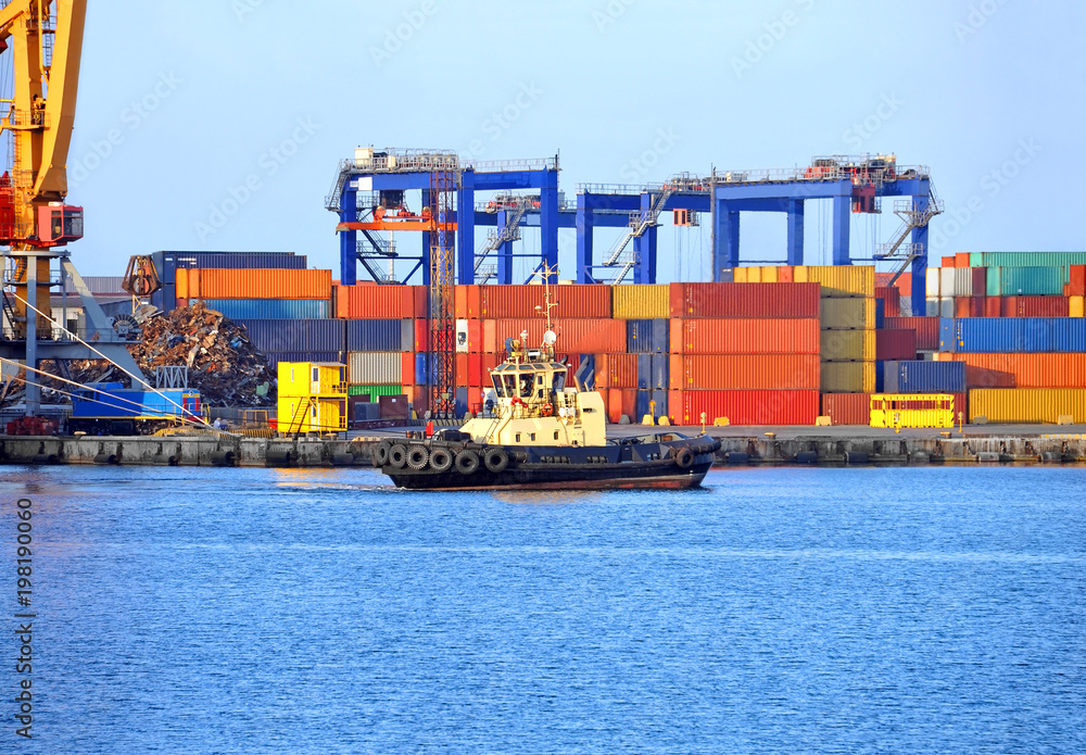 Fototapeta premium Tugboat and port cargo crane