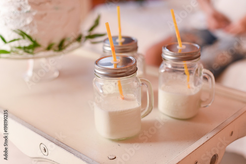 Glass cups with milk and straw