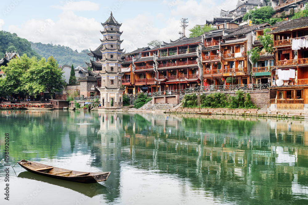 The Wanming Pagoda reflected in water of the Tuojiang River