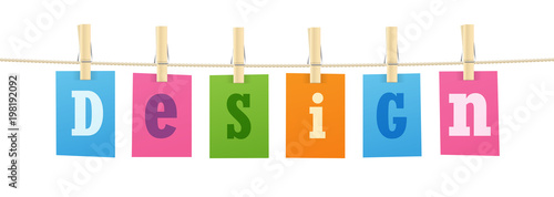 "DESIGN” letters pinned to string with pegs