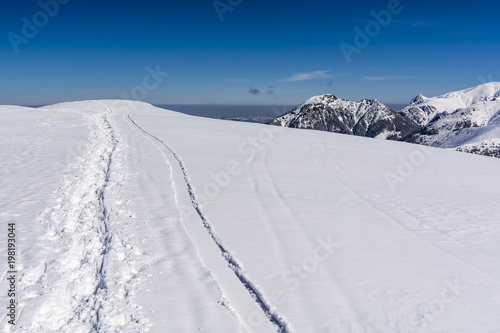 Trampled path in the snow by tourists on the ridge. © gubernat
