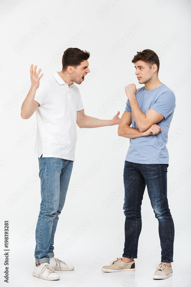 Full length portrait of two angry young men arguing Full length portrait of two angry young men arguing