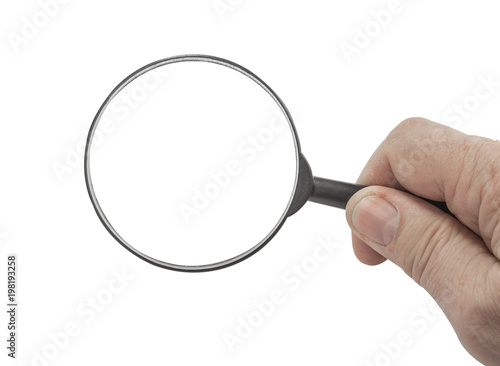 Magnifying glass in the hand on the white.