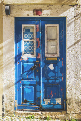 Old blue door in narrow street