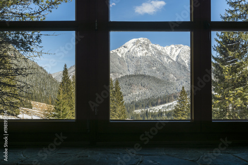 View through the window of the mountain hut to the top - Kominiarski Wierch. photo