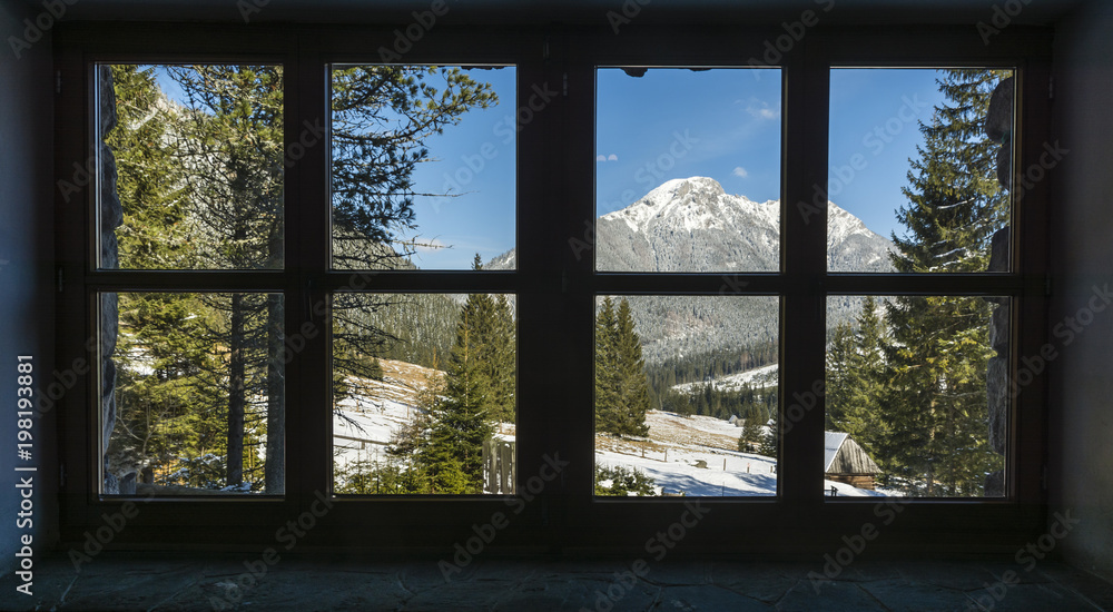 Obraz premium Kominiarski Wierch peak and Chocholowska valley seen from a window in a mountain hostel.