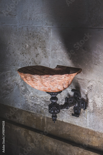 Obraz na plátne Holy water in the stone shell fount