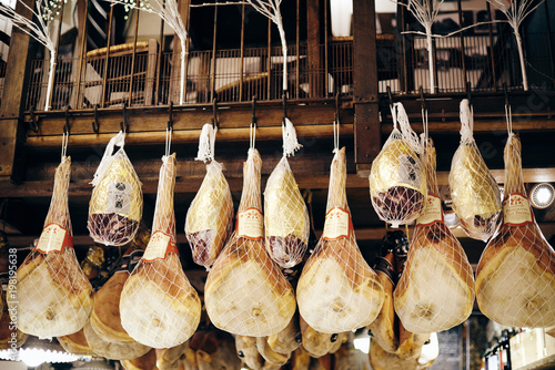 Cured ham hanging from the ceiling of a delicatessen in Bologna 