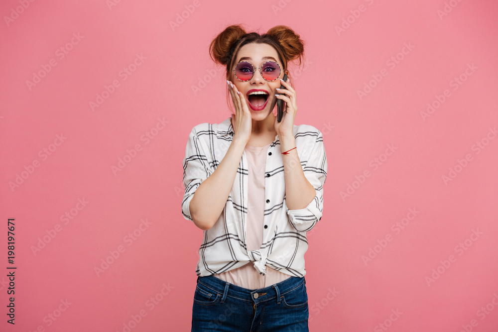Portrait of a surprised young girl talking on mobile Portrait of a surprised young girl talking on mobile