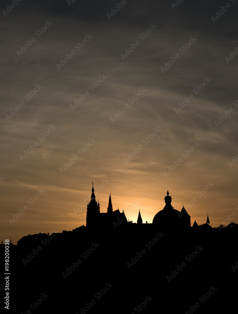 The outline of the old town houses, cathedrals and churches on sunset sky background. The historical centre of Prague. The European urban landscape