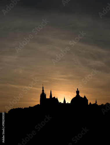 The outline of the old town houses, cathedrals and churches on sunset sky background. The historical centre of Prague. The European urban landscape