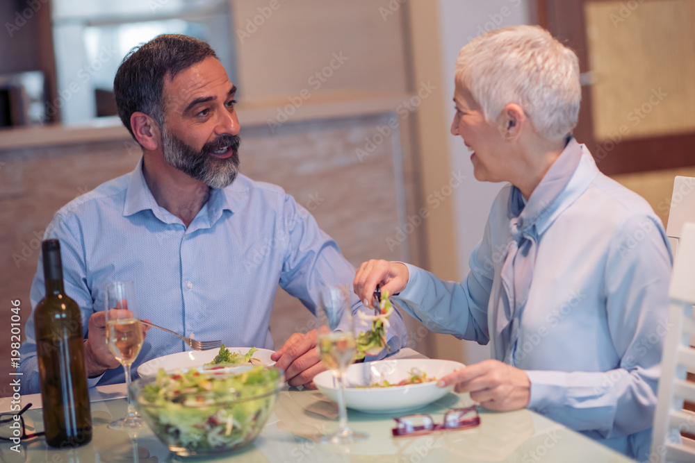 Senior people having lunch at home