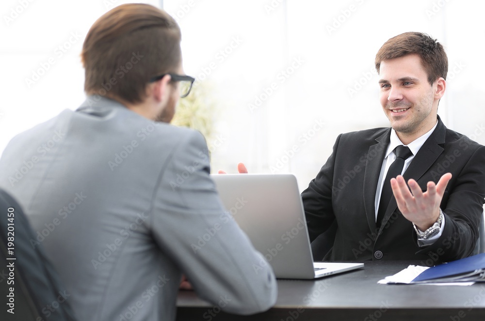 employees of the company talking at his workplace employees of the company talking at his workplace
