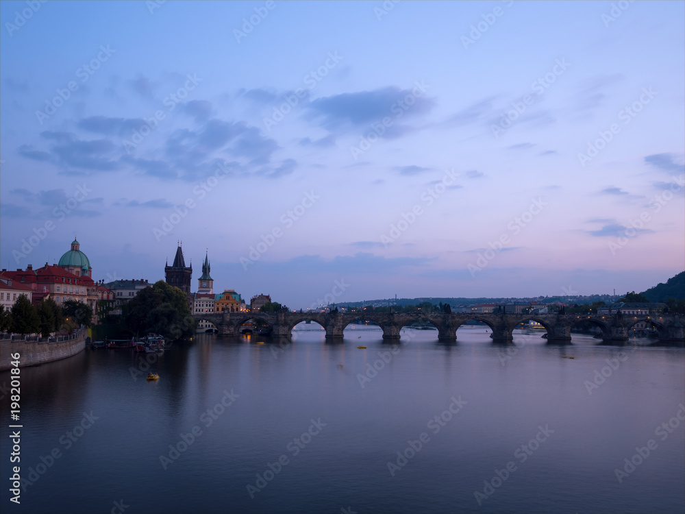 Late evening panorama of the famous medieval pedestrian only Charles bridge (Karluv Most) in the center of Prague, Czech Republic