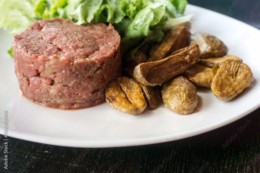 tasty Steak tartare (Raw beef) - classic steak tartare on white plate tasty Steak tartare (Raw beef) - classic steak tartare on white plate