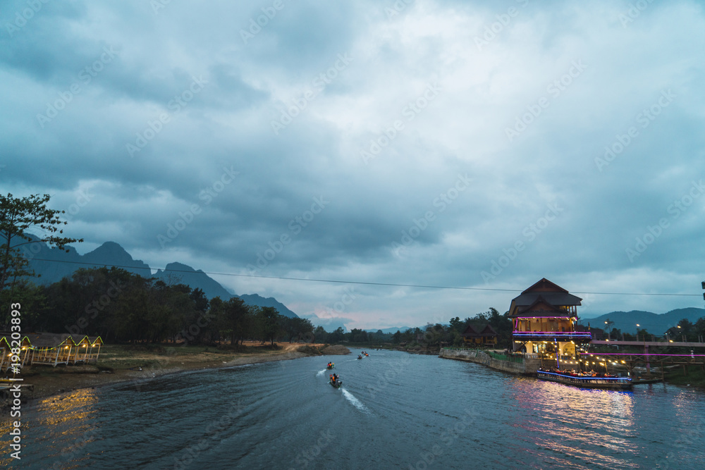 Boats sailing on river in evening Boats sailing on river in evening