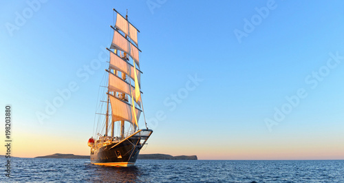 Sailing ship and beautiful sunset in the sea. Yachting. Sailing