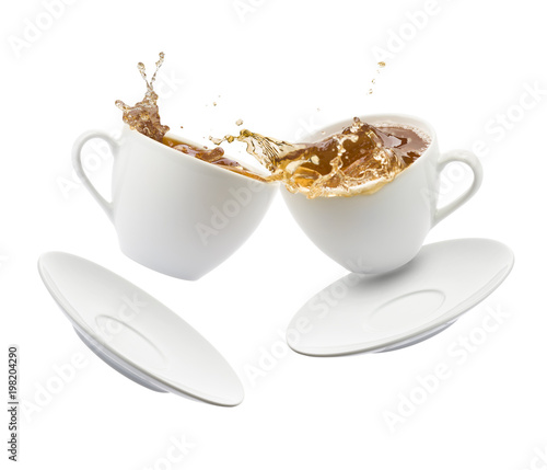 two cup of tea jumps and clash with splashing on white background