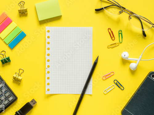 Business flat lay with copy space calculator, pencil, Notepad, coffee glasses on colorful yellow background