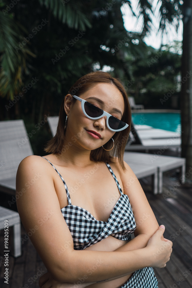 Pretty woman in sunglasses at pool Pretty woman in sunglasses at pool